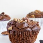 a close up of a chocolate cupcake with nuts